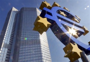 ** FILE ** A Euro sculpture is seen in the autumnal sun in front of the European Central Bank ECB building, background, in Frankfurt, Germany, on Sept. 24, 2007. The euro soared higher on Wednesday, Feb. 27, 2008, climbing to a high of US$1.5057 in early European trading as sentiment that the U.S. Federal Reserve would continue its rate cut campaign intensified when its chairman testifies before the U.S. Congress. (AP Photo/Bernd Kammerer)